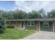 Charming ranch-style home with stone and green siding, complemented by a well-maintained yard at 6438 Doris Dr, Indianapolis, IN 46214