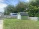 Storage shed in backyard with roll up garage door at 6438 Doris Dr, Indianapolis, IN 46214