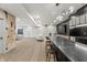 Well-lit basement featuring a bar with seating, a lounge area, and decorative walls at 9700 Windy Hills Dr, Zionsville, IN 46077