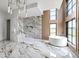 Luxurious bathroom with a soaking tub, a walk-in shower, and marble flooring at 9700 Windy Hills Dr, Zionsville, IN 46077