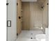 Modern bathroom with wood paneled shower, glass door, and minimalist design at 9700 Windy Hills Dr, Zionsville, IN 46077