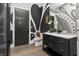 This trendy bathroom features black and white decor, a vanity, and modern gold fixtures at 9700 Windy Hills Dr, Zionsville, IN 46077