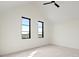 Bright bedroom featuring two windows overlooking a picturesque landscape view at 9700 Windy Hills Dr, Zionsville, IN 46077
