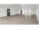 Spacious bonus room with light wood floors, high ceilings, and modern fixtures at 9700 Windy Hills Dr, Zionsville, IN 46077