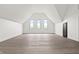 Light and airy bonus room with high ceilings, wood floors, and a row of large windows at 9700 Windy Hills Dr, Zionsville, IN 46077