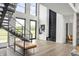Striking entryway with modern staircase, minimalist design, and abundant natural light at 9700 Windy Hills Dr, Zionsville, IN 46077