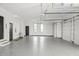 Spacious three-car garage features painted floors and bright lighting, with extra storage at 9700 Windy Hills Dr, Zionsville, IN 46077