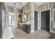 Stylish hallway with patterned wallpaper, modern light fixture, and a decorative console table at 9700 Windy Hills Dr, Zionsville, IN 46077