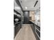Open concept kitchen featuring black cabinets, stainless steel appliances, and a large center island with unique light fixture at 9700 Windy Hills Dr, Zionsville, IN 46077