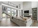 Modern living room featuring a fireplace, high ceilings, stylish decor, and an open staircase at 9700 Windy Hills Dr, Zionsville, IN 46077