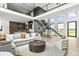 A beautifully staged living room features an open floor plan, modern staircase, and neutral color palette at 9700 Windy Hills Dr, Zionsville, IN 46077