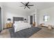 Spacious bedroom featuring a plush bed, modern lighting, and a dark rug at 9700 Windy Hills Dr, Zionsville, IN 46077