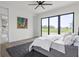 Main bedroom with a large window, neutral-toned bedding, and modern decor at 9700 Windy Hills Dr, Zionsville, IN 46077