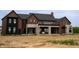 Back view of home featuring covered patio, mixed materials, and unfinished landscaping at 9700 Windy Hills Dr, Zionsville, IN 46077