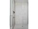 Modern shower featuring a glass enclosure, marble-look tile, built-in shelving, and stainless steel fixtures at 9700 Windy Hills Dr, Zionsville, IN 46077