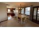 Bright dining room features a wood table with four chairs, and an open view to the kitchen at 1144 Woodridge, Brownsburg, IN 46112