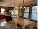 Bright dining area with a wood table and chairs, adjacent to a modern kitchen at 1144 Woodridge, Brownsburg, IN 46112