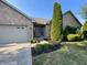 Brick home's front entrance with 2-car garage and landscaping at 1144 Woodridge, Brownsburg, IN 46112