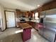 Updated kitchen with stainless steel appliances and wood cabinets at 1144 Woodridge, Brownsburg, IN 46112