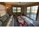 Bright sunroom with patio access, comfortable seating, and picturesque views at 1144 Woodridge, Brownsburg, IN 46112