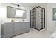 A sleek bathroom showcases a double vanity, a large mirror, and a glass-enclosed shower at 2936 N New Jersey St, Indianapolis, IN 46205