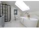 A luxurious bathroom features a skylight, freestanding tub, and a glass-enclosed shower at 2936 N New Jersey St, Indianapolis, IN 46205