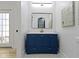 Stylish bathroom featuring a vibrant blue vanity with modern fixtures and updated lighting at 2936 N New Jersey St, Indianapolis, IN 46205