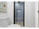 Modern bathroom featuring a glass-enclosed shower with gray tile and stone flooring at 2936 N New Jersey St, Indianapolis, IN 46205