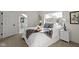 Bedroom with a bed dressed in white linens, a window, and a peek into an en suite bathroom at 2936 N New Jersey St, Indianapolis, IN 46205