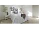 Bright bedroom featuring a comfortable bed with white bedding, a window, and a nightstand at 2936 N New Jersey St, Indianapolis, IN 46205