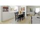 Bright dining area with black wood table, hardwood floors, and a large window for natural light at 2936 N New Jersey St, Indianapolis, IN 46205