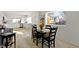 Bright dining area with black wood table, hardwood floors, and view into the modern white kitchen at 2936 N New Jersey St, Indianapolis, IN 46205