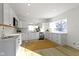 Modern kitchen with stainless steel appliances, white cabinets, and natural light from the window at 2936 N New Jersey St, Indianapolis, IN 46205