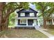Charming two-story home with inviting front porch and mature trees in a desirable neighborhood at 3031 N New Jersey St, Indianapolis, IN 46205