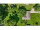 Aerial view of a home with a well-manicured lawn and mature trees offering privacy, surrounded by green space at 105 Tulip Dr, Indianapolis, IN 46227
