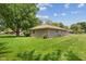 View of the home's backyard, featuring a large green lawn at 105 Tulip Dr, Indianapolis, IN 46227