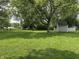 Large backyard with a storage shed and mature trees, perfect for outdoor activities at 105 Tulip Dr, Indianapolis, IN 46227