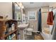 Bathroom showcasing a pedestal sink, toilet, and tub with tile at 105 Tulip Dr, Indianapolis, IN 46227