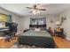 Bedroom with hardwood floors, ceiling fan, desk, and ample natural light at 105 Tulip Dr, Indianapolis, IN 46227