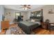 Cozy bedroom featuring hardwood floors, a ceiling fan, and natural light at 105 Tulip Dr, Indianapolis, IN 46227
