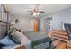 Bedroom features wood floors, ceiling fan, and windows, and access to other rooms at 105 Tulip Dr, Indianapolis, IN 46227