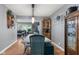 View of the dining room area with hardwood floors, pendant lighting, and seating for six at 105 Tulip Dr, Indianapolis, IN 46227