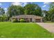 Front exterior of a home highlighting a well-kept lawn, established trees, and a single-car attached garage at 105 Tulip Dr, Indianapolis, IN 46227