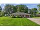 Charming single-story home featuring a well-maintained lawn, colorful bushes, and an attached one-car garage at 105 Tulip Dr, Indianapolis, IN 46227