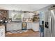 Bright kitchen with white cabinets, stainless steel appliances, and stone backsplash at 105 Tulip Dr, Indianapolis, IN 46227