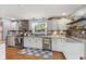 Well-lit kitchen featuring stainless steel appliances, tile backsplash, and hardwood floors at 105 Tulip Dr, Indianapolis, IN 46227