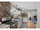 Well-lit kitchen featuring stainless steel appliances, stone backsplash, and hardwood floors at 105 Tulip Dr, Indianapolis, IN 46227