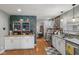 Spacious kitchen with white cabinets, tile backsplash, stainless appliances, and hardwood floors at 105 Tulip Dr, Indianapolis, IN 46227