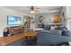 Comfortable living room featuring hardwood floors, a sectional sofa, and a flat-screen TV at 105 Tulip Dr, Indianapolis, IN 46227