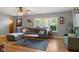 Inviting living room with hardwood floors, sectional sofa, and large windows providing natural light at 105 Tulip Dr, Indianapolis, IN 46227